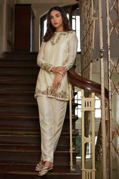 Beautiful off white short shirt with multicolor thread embroidery over the sleeves and neck, match with straight off white silk pant. ✨Dazzle with this elegant dress in any party or function. ✨We stitched outfit with lot of care, so that our customers should not have any issues regarding finishing and fitting. ✨This dress can be customise in any other colour and in all size, please contact us regarding any changes if you want.We will make this dress as per customer requirement. ✨ Our dresses tak Suits For Women Indian, Silk Kurti Designs, Floral Embroidered Shirt, Pant Suits For Women, Latest Designer Dresses, Kurta Pant Set, Silk Kurti, Party Kleidung, Indian Designer Outfits