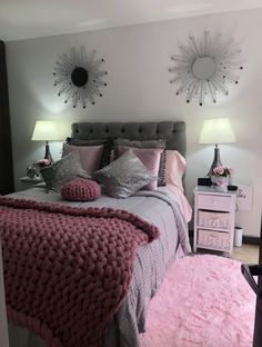 a bedroom decorated in pink and grey colors