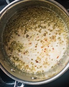 the food is being cooked in the pot on the stove