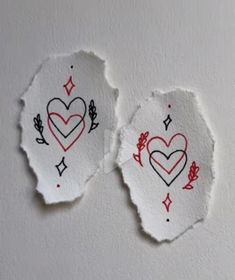 two torn pieces of paper with hearts on them