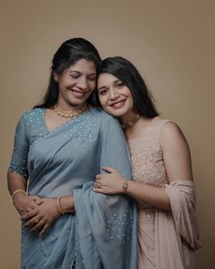 two women standing next to each other smiling