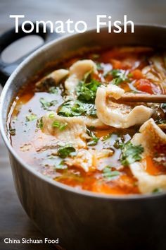 a pot filled with tortellini soup on top of a wooden table