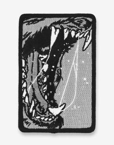 a black and white patch with an image of a monster's mouth on it