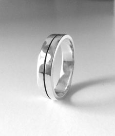 a silver ring with two black lines on it