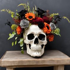 a skull with flowers on its head sitting on a table