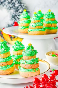 green frosted christmas trees on top of cookies and pastries with candy in the background