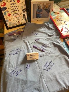 a table with several items on it including a t - shirt and two framed pictures