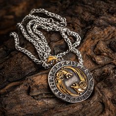 There are times when the moon is full and we want to feel its power. Other times, we want to represent our inner wolf. This Dual Colored Stainless Steel Circular Twin Wolf Necklace does both, with a special ring of runes surrounding two wolves engraved in gorgeous detail on this high quality stainless steel pendant. Also features a Helm of Awe on the reverse with the inscription: "The brave shall live forever in the halls of Valhalla" Pendant is approx. 1.5" across (4cm) and comes complete with Viking Style Silver Jewelry With Wolf Design, Viking Style Silver Wolf Design Jewelry, Viking Style Metal Round Pendant Jewelry, Viking Style Wolf Design Jewelry Gift, Halls Of Valhalla, Helm Of Awe, Two Wolves, Wolf Necklace, Special Ring