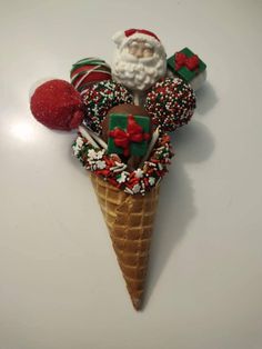 an ice cream cone filled with candy and candies on top of a white table