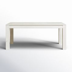 a white table sitting on top of a white floor