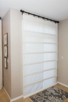 a bathroom with a shower curtain and rug on the floor