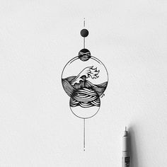 a drawing of an ocean wave in a glass ball on a white wall next to a marker