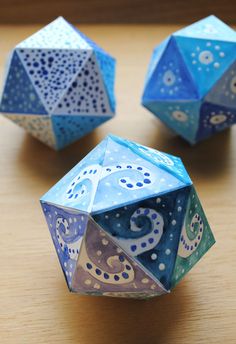 three blue and white dices sitting on top of a wooden table