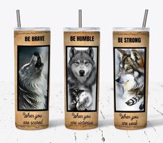 three stainless steel tumblers with pictures of wolfs and the words be brave on them