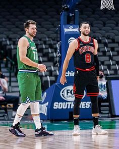 two basketball players are standing on the court