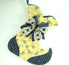 an ornament made out of fabric with polka dots and a bow on it