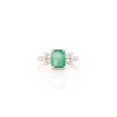 This is part of Chairish’s Fine Jewelry assortment.  1.34 Carat Octagon Emerald and Diamond Leaf Ring in 14K Gold featuring natural emerald of 1.34 carats and diamonds of 0.25 carats. The gorgeous handcrafted ring goes with every style. Emerald enhances intellectual capacity of the person.  Designed with octagon cut emerald set in center with diamonds on both side making leaf that makes it a perfect fit to wear it on your wedding or style it with any of your basic outfit to give it a glam. This Emerald Cut Cluster Ring With Vvs Clarity, Emerald Cut Green Cluster Ring With Diamond Accents, 14k Gold Octagon Emerald Ring Fine Jewelry, Octagon Brilliant Cut Emerald Jewelry, Octagon Emerald Jewelry With Diamond Accents, Green Emerald-cut Cluster Ring With Diamond Accents, Fine Jewelry Octagon Emerald, Octagon Emerald Ring In Platinum, Fine Jewelry, Diamond Leaf Ring