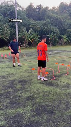 two men are playing frisbee golf on the grass