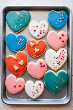 heart shaped cookies are arranged on a cookie sheet