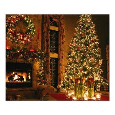 a living room decorated for christmas with lit trees and candles in front of the fireplace