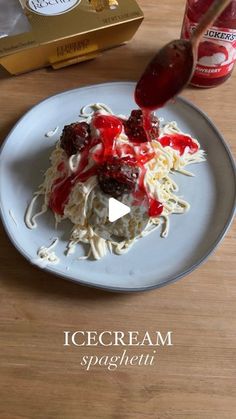 a white plate topped with pasta and toppings next to a box of ice cream