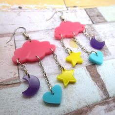 Add to your Decora Style with these Pastel Dream Cloud and Charms Dangle Earrings! ⭐ These absolutely adorable cloud with star, heart and moon charms are made of laser cut pink, purple, teal and yellow acrylic! ☁ Super lightweight decora dangle earrings measure about 1.15″ wide and hangs 2.5″ long! 💙 Pick which hooks these cute kawaii pendants hang on! Pick from: ~ Nickel Free Hooks ~ Stainless Steal Hooks ~ Plastic Hooks ~ Clip Ons ~ Titanium Hooks 🌙 These Pastel Dream Charm Dangle Earrings m Cute Rainbow Dangle Earrings, Cute Star Charm Dangle Earrings, Cute Dangle Earrings With Star Charm, Kawaii Multicolor Dangle Earrings, Multicolor Dangle Earrings In Kawaii Style, Cute Dangle Heart Earrings, Cute Hypoallergenic Heart Earrings, Pink Star-shaped Kawaii Jewelry, Cute Handmade Dangle Heart Earrings