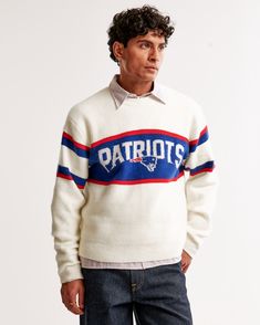 NFL New England Patriots sweater in our soft sweater-knit fabric and oversized-fit silhouette, featuring a slightly cropped body length, New England Patriots script graphic logo detail at chest, arm band details, crew neckline and banded hem and cuffs. Sweaters To Knit, Knit Vests, Men's Sweaters, Cozy Cardigan, Graphic Logo, Soft Sweater, Mens Fall, New York Jets, Kansas City Chiefs