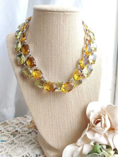 "This is my best selling vintage citrine rhinestone necklace Inspired by the georgian collet necklaces worn by Style Icon, Anna Wintour. These lovely citrine colored vintage rhinestones are limited and precious. And this is one amazing necklace. This sparkly piece is Lovely when paired with other longer necklaces, perfect for layering to add a zip of color. Wonderful on a cloudy day! *This necklace is 16 inches long with a 2\" extender for the perfect fit. *The settings are heavy sterling silver Vintage Luxury Chain Necklace For Evenings, Formal Double Strand Faceted Jewelry, Vintage Jeweled Necklace For Anniversary, Yellow Costume Jewelry For Formal Occasions, Faceted Yellow Jewelry For Wedding, Faceted Amber Jewelry For Wedding, Vintage Double Strand Jewelry For Formal Occasions, Formal Yellow Faceted Jewelry, Vintage Amber Jewelry For Party