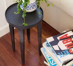 a table with magazines and a plant on it