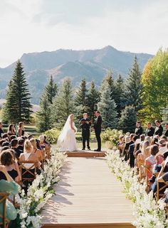 a bride and groom standing at the end of their wedding ceremony