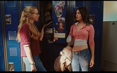 two young women standing in front of lockers