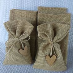 two small bags with hearts tied to them