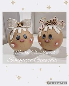 two decorated eggs sitting on top of a table next to each other, with the words merry christmas written below them