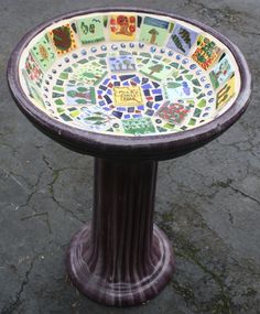 a colorful mosaic bowl on top of a pedestal