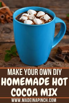 homemade hot cocoa mix in a blue mug with marshmallows and cinnamon on top