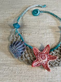 A truly gorgeous, one of a kind crocheted necklace. Made using pure cotton. It features some very detailed designs, inspired by the sea and marine life🐚🌊 Handmade Ocean Color Necklaces For Beach, Bohemian Crochet Jewelry For The Beach, Bohemian Crochet Jewelry For Beach, Bohemian Crochet Beach Jewelry, Bohemian Beaded Necklaces With Crochet For Beach, Bohemian Crochet Beaded Necklaces For The Beach, Bohemian Beaded Crochet Necklaces For Beach, Ocean-inspired Starfish Beaded Necklaces, Bohemian Crochet Necklaces For Beach