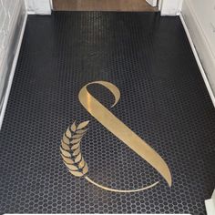 a black and gold floor with a logo on it