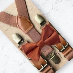 "This burnt orange floral bow tie & brown suspenders set is a great choice for a bowtie for a terracotta wedding, fall wedding, autumn ring bearer gift, boho wedding, bow ties for men, ring bearer outfit, any other special occasion. ❤ **Please Specify**  Bow Tie Only (w/ Clip or Neck Strap), Suspenders Only, or Bow Tie Only & Susp (Bow Tie and Suspenders) SUSPENDERS- One Pair of our Quality Suspenders BOW TIE - One Bow Tie on White Adjustable STRAP or Alligator CLIP PET BOWTIE w/ Elastic Loops- Slips on a Dog/Cat/Pet Collar **CLIP ON Bow Ties are Recommended/Suitable for Children Only X-Small: 6 months- 2 years Small: 3 years- 5 years Medium: 6 years- 10 years Large: 10 years- Up To 6ft tall Adult: Adults Over 6ft Tall RUSH MY ORDER- Need you order ASAP? Simply add this to your cart before Adjustable Brown Bow Tie For Party, Brown Party Suspenders, Classic Brown Belts And Suspenders For Wedding, Elegant Brown Belts And Suspenders For Wedding, Elegant Brown Belts And Suspenders For Party, Adjustable Brown Belts And Suspenders With Bow, Brown Satin Bow Tie For Wedding, Fall Ring Bearer, Terracotta Bow Tie