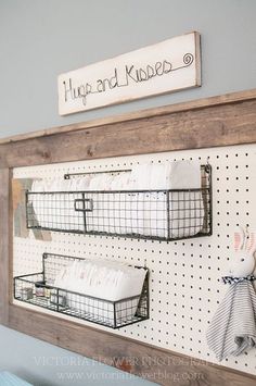 two baskets are hanging on a peg board