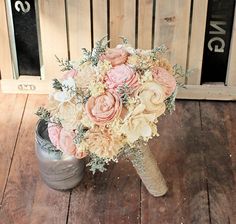 a bouquet of flowers sitting on top of a wooden floor