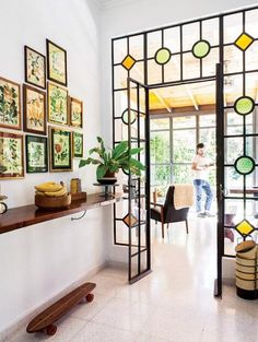 a living room filled with furniture and pictures on the wall