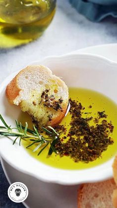 a white bowl filled with olive oil and bread