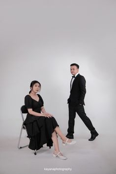 a man and woman in formal wear sitting next to each other