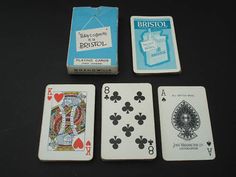 four playing cards are sitting next to each other