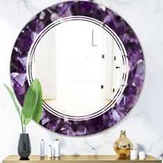 a mirror that is sitting on top of a table next to a vase and some candles