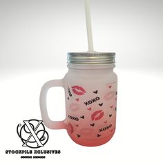 a mason jar with a straw in it and lipstick prints on the lid is shown