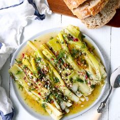 a white plate topped with artichoke and bread