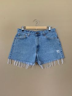 "High waisted 90's denim shorts. Made by Levi's Jeans in light blue denim wash. Shorts are in excellent clean condition. Perfectly worn in with light naturally distressed character and handmade wear holes. These have been cut off and washed once. Measurements are taken zipped or buttoned up and laid comfortably flat then x 2 for total circumference (inches) Tag Size 13 Levis 555 100% Cotton Made in USA Waist 34\" Hips 46\" Length 14\" Inseam 3\" Rise 12\" leg opening circumference 26\" All items Retro Spring Jean Shorts With Frayed Hem, Vintage Relaxed Fit Cutoff Jeans, Retro Cutoff Jeans For Summer, Retro Cutoff Summer Jeans, Vintage Denim Blue Cutoff Bottoms, 90s Fitted Cutoff Bottoms, Vintage Medium Wash Relaxed Fit Jean Shorts, 90s Style Fitted Cutoff Bottoms, Vintage Mid-rise Relaxed Fit Jean Shorts