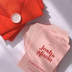 several red envelopes are next to each other on a white surface with a wax stamp