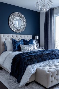 a bedroom with blue walls, white bedding and a chandelier hanging from the ceiling